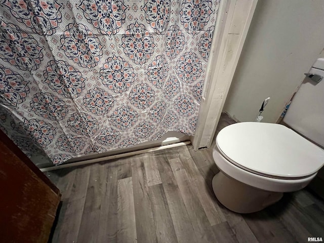 bathroom featuring hardwood / wood-style flooring and toilet