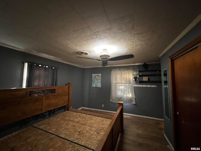 bedroom with dark hardwood / wood-style flooring and ornamental molding