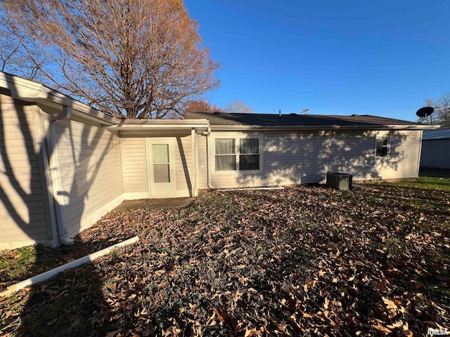 rear view of property with central AC unit