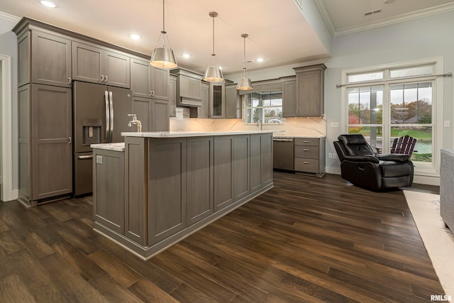 kitchen with a healthy amount of sunlight, stainless steel appliances, hanging light fixtures, and dark wood-type flooring