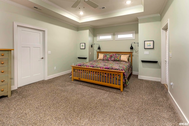 carpeted bedroom featuring a raised ceiling, ceiling fan, and ornamental molding