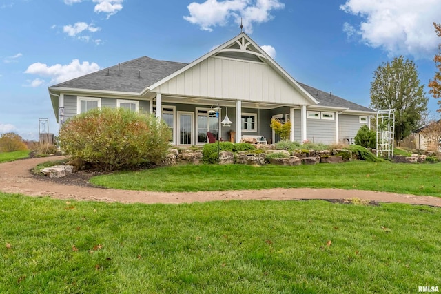 view of front of property with covered porch and a front yard