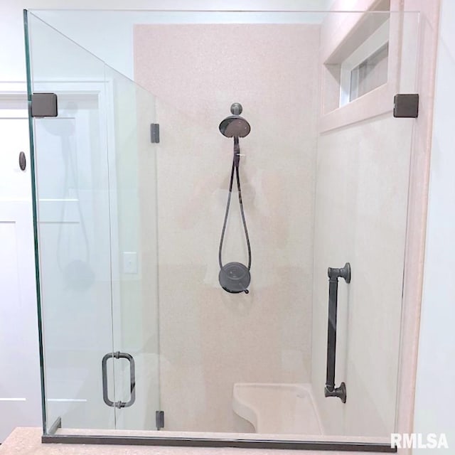 bathroom with a shower with shower door