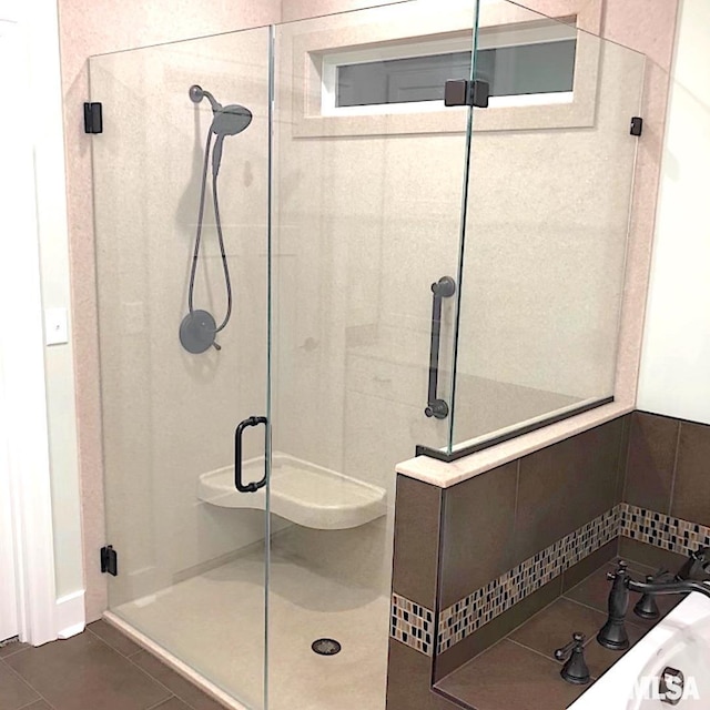 bathroom with tile patterned flooring and a shower with door