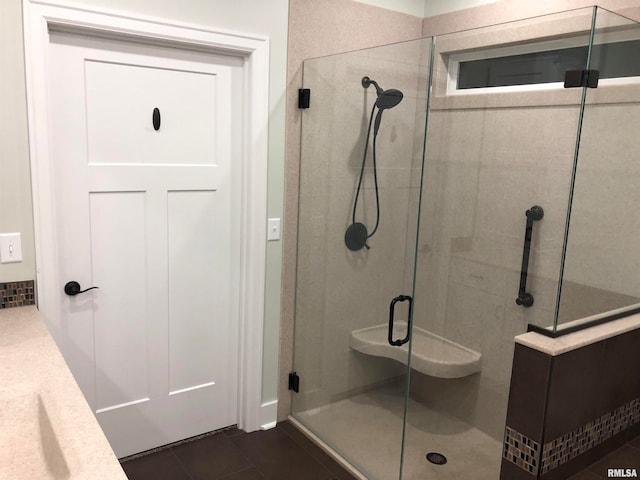 bathroom featuring tile patterned flooring, vanity, and a shower with shower door