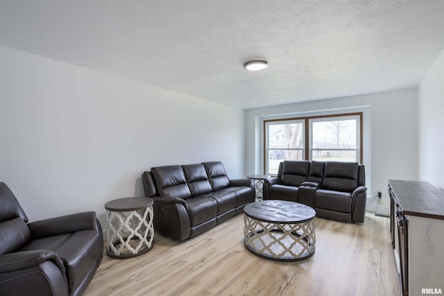 living room featuring light wood-style floors and a textured ceiling