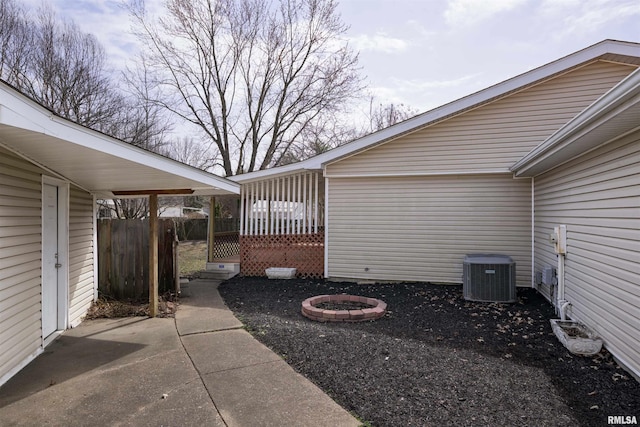 view of patio featuring fence, a deck, and central air condition unit