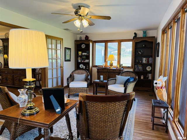 living room featuring ceiling fan, hardwood / wood-style floors, and french doors