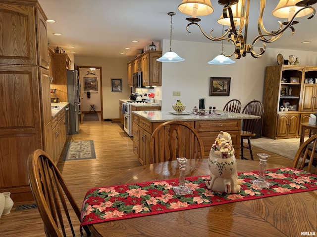 dining area featuring a chandelier and light hardwood / wood-style floors