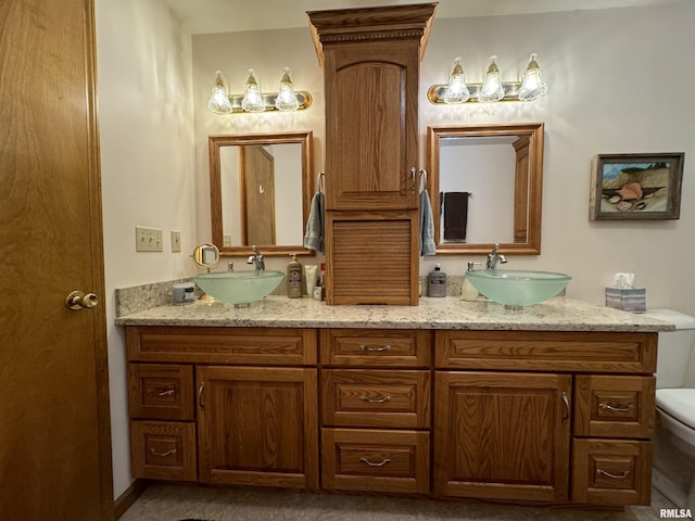 bathroom featuring vanity and toilet