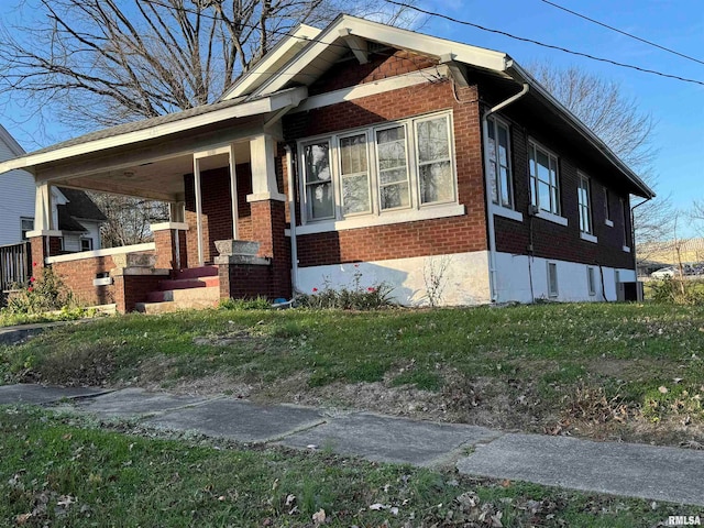 view of side of home with a porch