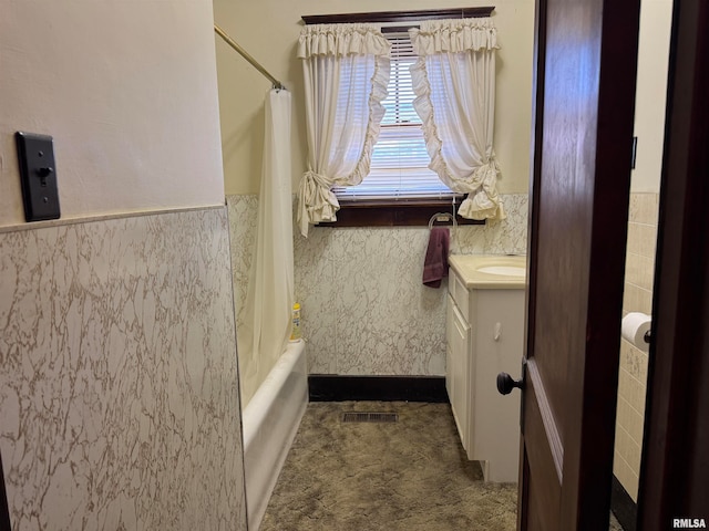 bathroom with vanity, shower / bath combination with curtain, and tile walls