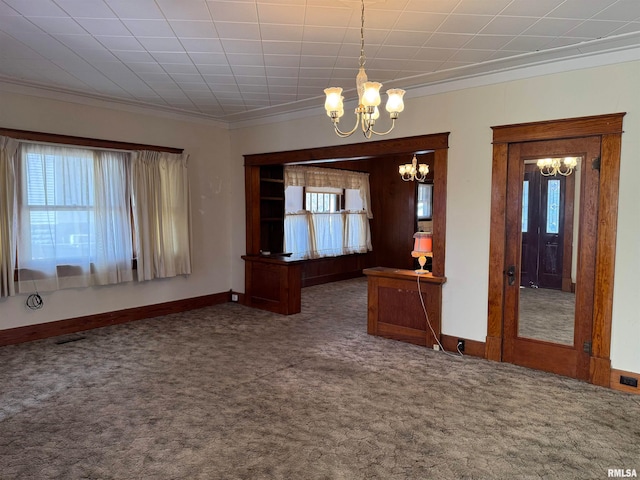 carpeted spare room with an inviting chandelier, a healthy amount of sunlight, and crown molding