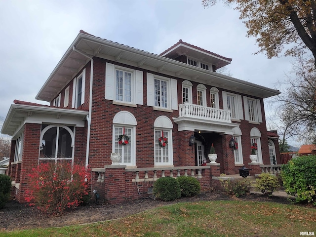 view of front of property featuring a porch and a balcony