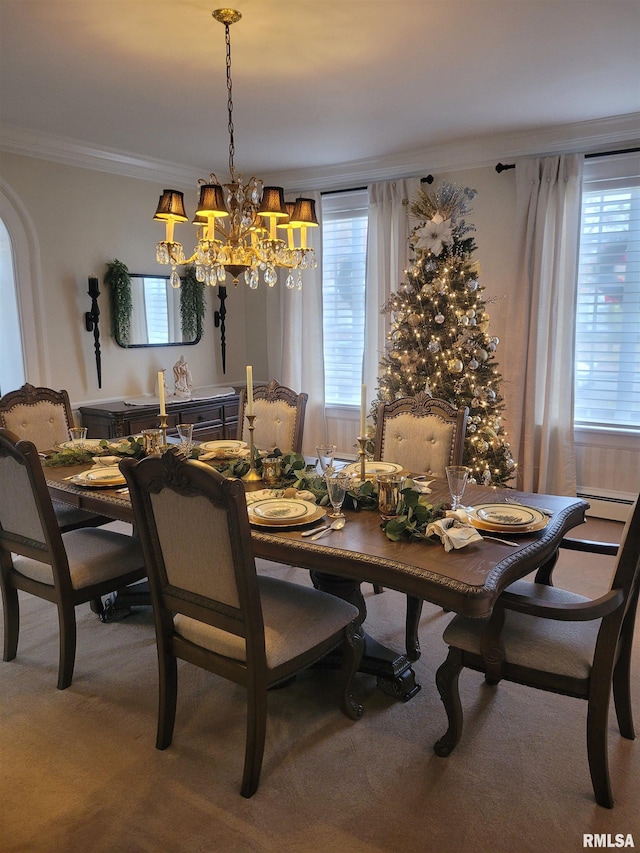 carpeted dining space with crown molding and a notable chandelier