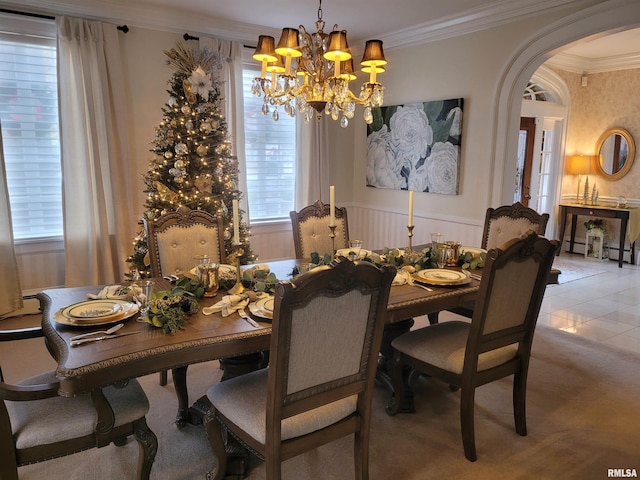 tiled dining room with a chandelier, a baseboard radiator, and ornamental molding