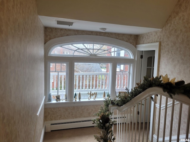 foyer entrance with a baseboard radiator