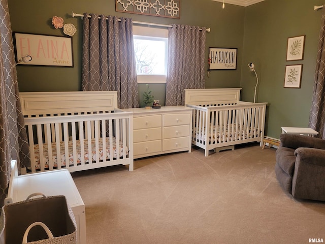 bedroom with light colored carpet, crown molding, and a nursery area