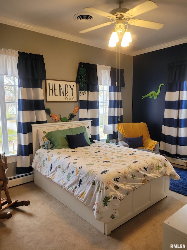 carpeted bedroom with ceiling fan, crown molding, and a baseboard heating unit