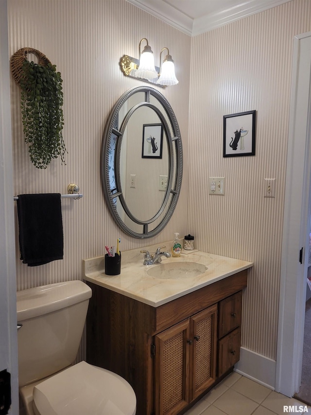 bathroom featuring tile patterned floors, toilet, vanity, and ornamental molding