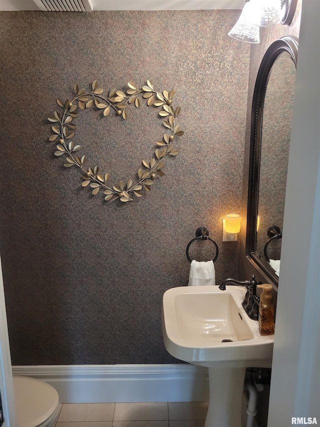 bathroom with tile patterned flooring and toilet