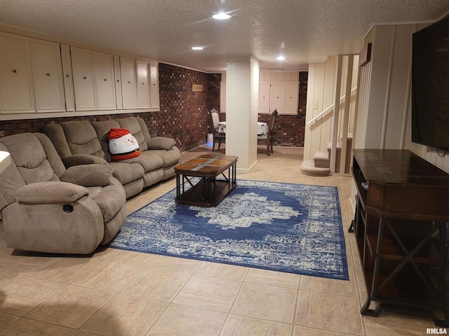 living room with light tile patterned floors, a textured ceiling, and brick wall