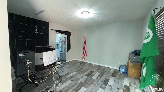 miscellaneous room with hardwood / wood-style flooring and a textured ceiling