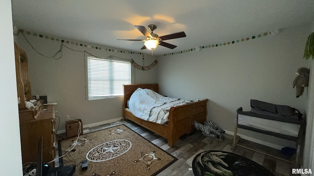 bedroom featuring ceiling fan and light hardwood / wood-style flooring