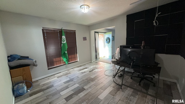 office space with light hardwood / wood-style flooring and a textured ceiling