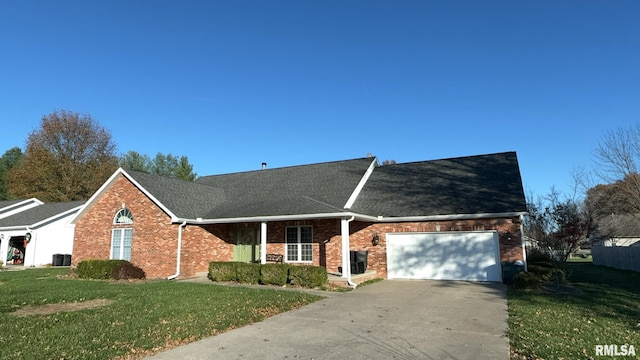 view of front of house with central AC unit, a front yard, and a garage