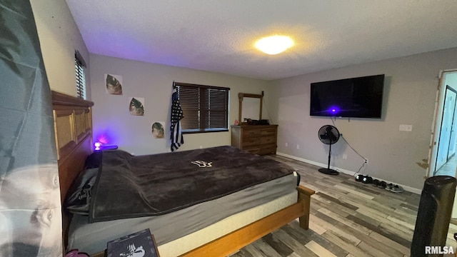 bedroom featuring wood-type flooring and a textured ceiling