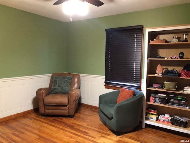 sitting room with ceiling fan and hardwood / wood-style floors