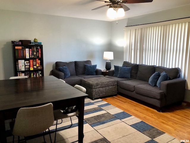 living room with light hardwood / wood-style flooring and ceiling fan