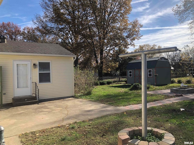 view of yard featuring a patio and a shed