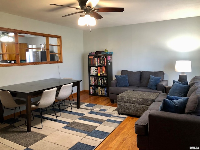 living room with ceiling fan and light hardwood / wood-style flooring