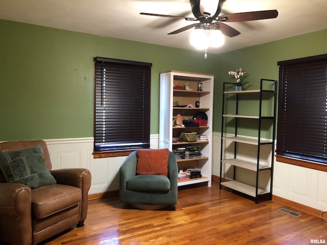 living area with ceiling fan and wood-type flooring