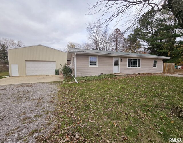 ranch-style house with an outbuilding, a front yard, and a garage