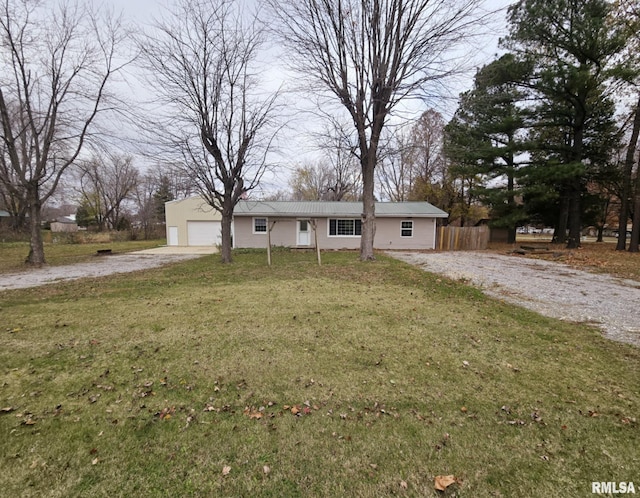 ranch-style house with a garage and a front lawn