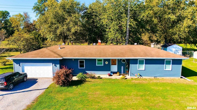 single story home featuring a garage and a front lawn