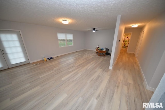 unfurnished room featuring french doors, a textured ceiling, light hardwood / wood-style floors, and ceiling fan