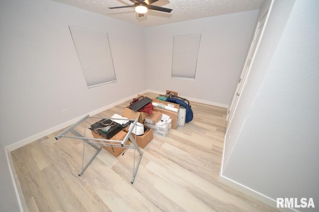 miscellaneous room with hardwood / wood-style floors, ceiling fan, and a textured ceiling