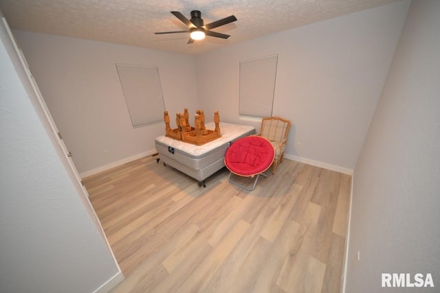 bedroom with a textured ceiling and light hardwood / wood-style floors