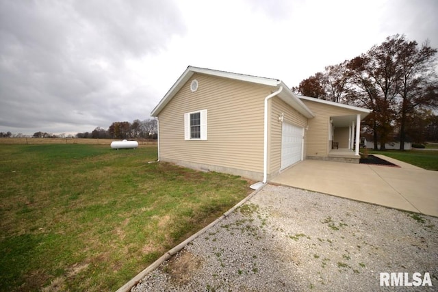 view of side of home with a lawn and a garage