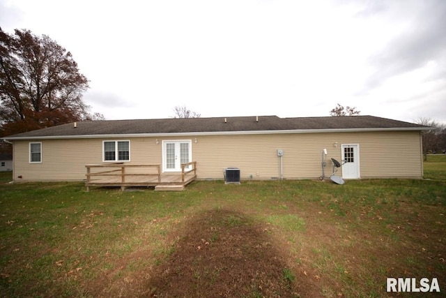 rear view of house featuring a lawn, a wooden deck, and central AC unit