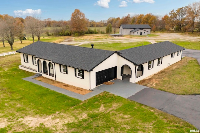 view of front of property with a garage and a front lawn