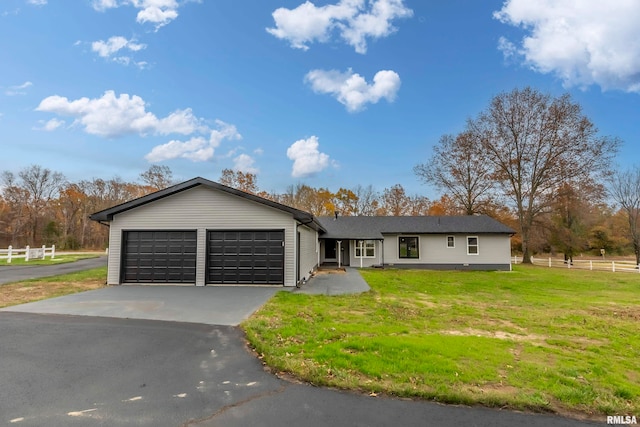 ranch-style home with a garage and a front yard