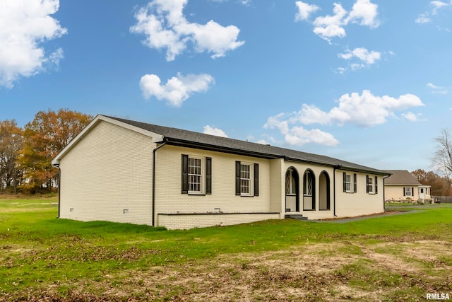 back of property featuring a lawn