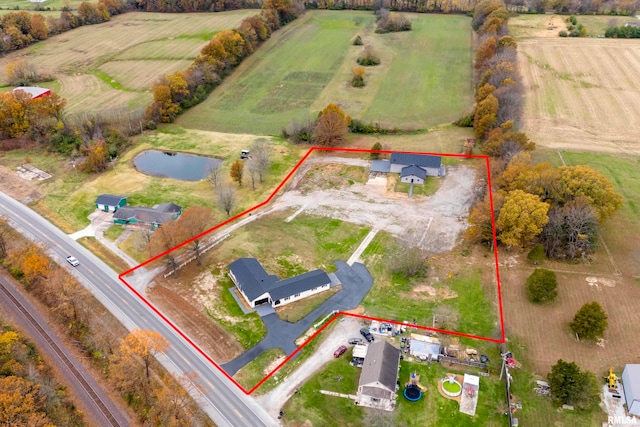 birds eye view of property with a rural view