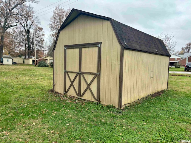 view of outbuilding featuring a yard