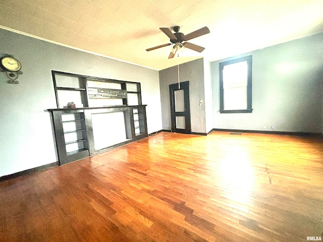 unfurnished living room featuring hardwood / wood-style floors and ceiling fan